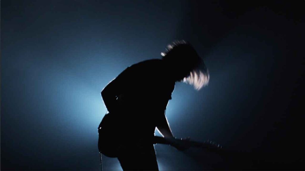 silhouette or rock guitar player with haze